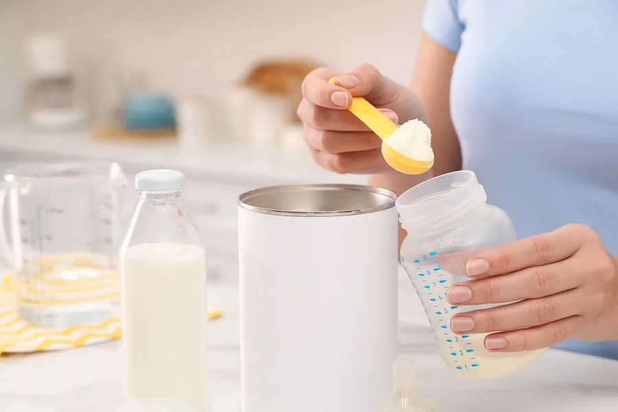 Mother preparing infant formula